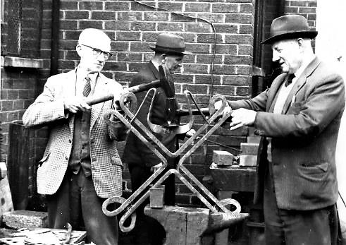 Brothers Hugh (left) and Thomas McCullough are hard at work on the re-construction of St. Brendan’s Church of Ireland at Larkfield Road which had collapsed during a storm. They were part of a volunteer contingent of retired shipyard workers, who it was reported, spent 25-30 hours per week ‘on the job’ putting their ‘wealth of talent’ to good use. During their tea break they would talk about old times in ‘The Yard’. All the mild steel and equipment such as anvils and tools were provided by John Eastwood and Sons, whilst the British Oxygen Company supplied an oxy-acetylene cutter. St Brendan’s was re-consecrated in October 1967 and during the sermon Bishop Alan Buchanan remarked that ‘In 1963 your church stood after many years of waiting. Then it was almost razed to the ground. Now it has risen again’.  