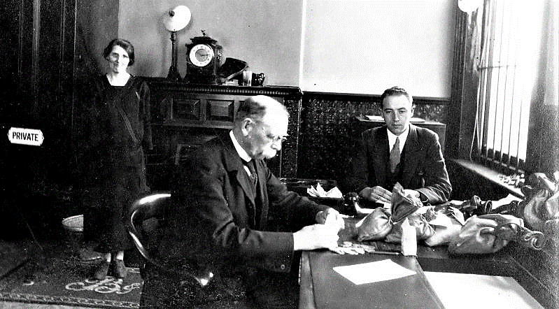 Robert Dowling (right) was appointed Assistant Cashier in 1910 at the Belfast & County Down Railway (BCDR) headquarters, Queen’s Quay. It is now the site of the Odyssey entertainment complex. Here he is hard at work, in the 1930s, making up the weekly payroll (in cash) with Chief Cashier Mr. Evans. Part of Robert’s job was to take a journey around the 49 stations and halts on the BCDR rail network, along with wife Lottie and daughter Rosemary, to hand out the pay packets. 